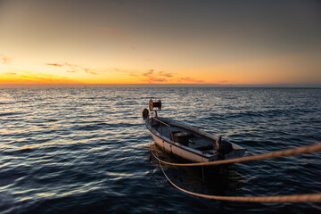 Fishing boat on dock and sunset