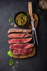 Foto op Canvas Different degrees of steak roasting. Steak with blood, medium to high roast steak on a wooden board © Yulia Furman