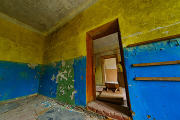 Obraz na płótnie Canvas Old shabby building interior with scratched colorful walls