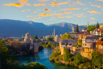 Fantastic Skyline of Mostar with the Mostar Bridge, houses and minarets, at sunset. Location:...
