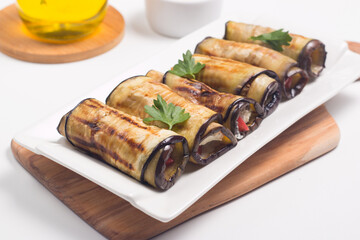 Baked grilled eggplant rolls with cottage cheese, tomatoes and sour cream. Georgian cuisine. 