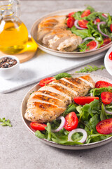 Salad with grilled chicken fillet meat, fresh vegetables, spinach, ruccola, red onion and tomato. Healthy menu. Diet food. Top view. Banner 