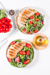 Salad with grilled chicken fillet meat, fresh vegetables, spinach, ruccola, red onion and tomato. Healthy menu. Diet food. Top view. Banner 