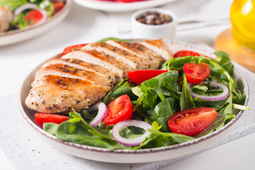 Salad with grilled chicken fillet meat, fresh vegetables, spinach, ruccola, red onion and tomato. Healthy menu. Diet food. Top view. Banner 