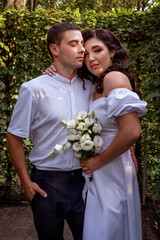 Young attractive couple retired to the park. The lovers hugging look into the camera