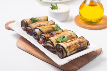 Baked grilled eggplant rolls with cottage cheese, tomatoes and sour cream. Georgian cuisine. 