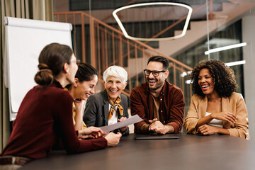 Smiling business people, working together on the new project, talking, sharing plans.
