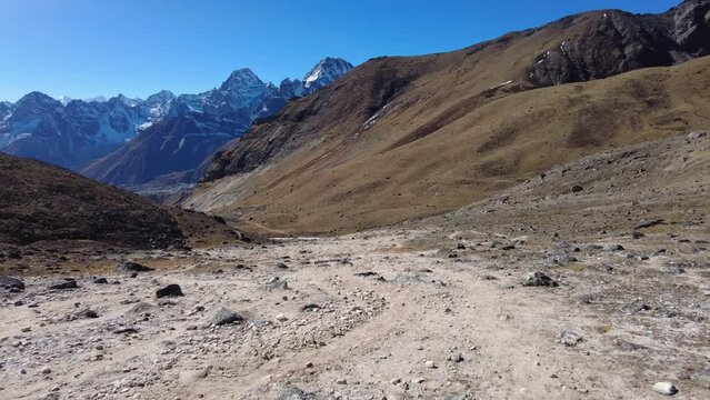 Cho La Pass, Nepal: Point of view of an hiker walking down the Chola pass toward Dragnag, or Thragnak, in the Gokyo valley coming from the Everest base camp in the Himalayas in Nepal. 