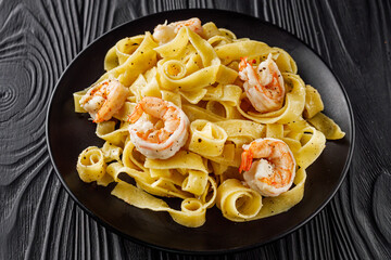 delicious shrimp fettuccine alfredo pasta on a black rustic background