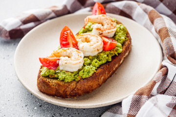 delicious Italian bruschetta with shrimps on a gray stone background