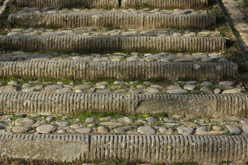 medieval staircase consisting of different stones and pieces of marble leading up