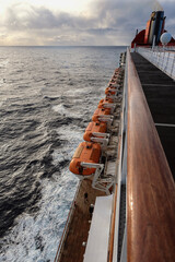 View from deck over bow and side of legendary luxury ocean liner cruise ship on passage during...