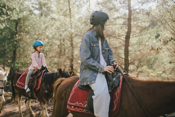 Group of people walking on horseback through picturesque places.