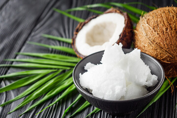 fresh natural coconut butter on black wooden background