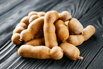 sweet and sour tamarind on a black rustic wooden background
