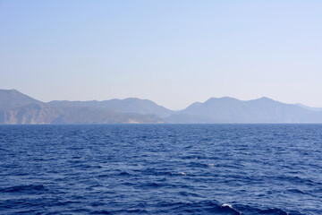 blue mediterranean sea with mountain range on background isolated