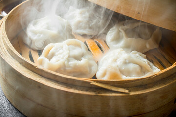Hot dumplings manta in a bamboo steamer.