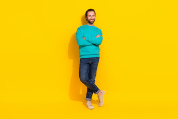 Fototapeta na wymiar Full length photo of cool cheerful guy dressed teal outfit arms folded smiling isolated yellow color background