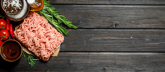 Raw ground beef with tomatoes and spices.