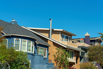 Row of modern decorative houses in neighborhood of downtown city streets with blue and beige exteriors