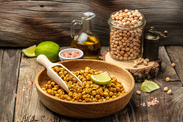 fried spicy chickpeas with lime on wooden table background. banner, menu, recipe place for text, top view