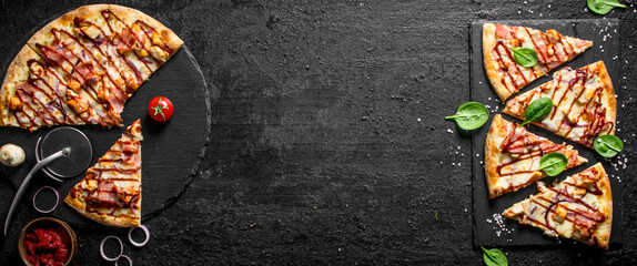 Cut barbecue pizza on a stone Board.