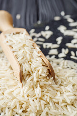 raw basmati rice on a black wooden background