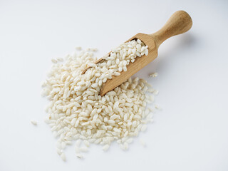 arborio rice for risotto on a white acrylic background