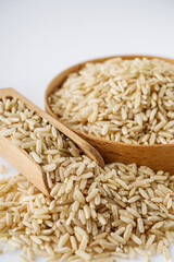 raw unpolished rice on a white acrylic background