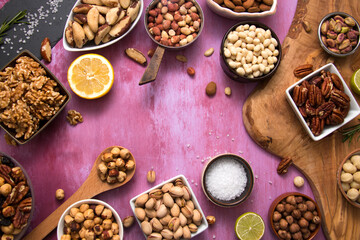 Table full of different nuts on background