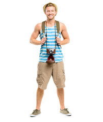 A handsome young tourist standing alone in the studio while carrying his camera and backpack isolated on a PNG background. - obrazy, fototapety, plakaty