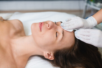 Fototapeta na wymiar Top view of face massage in salon