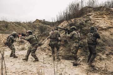 Soldiers on a shooting range looking concentrated and attentive
