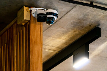 Modern video surveillance cameras with remote Internet access inside the store. Security systems in a nightclub and restaurant. Close-up round CCTV camera on ceiling