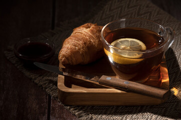 Evening tea and croissants on the table in the kitchen