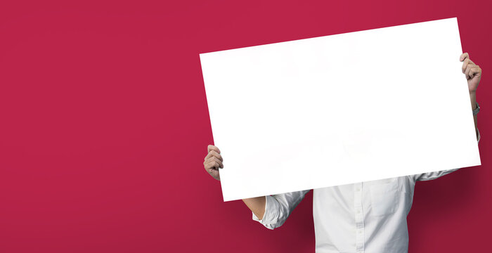 Man holding the big banner at red background.