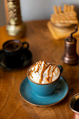 Obraz na płótnie Canvas Cappuccino cup with cream and sauce