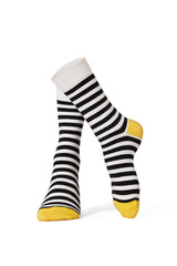 Detailed shot of colored striped socks with a wide rubber band. The socks are shaped as human legs. The black and white striped socks with yellow heel and toe are isolated on a white background.