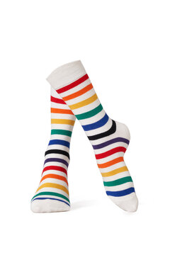 Detailed shot of bright colorful rainbow striped socks with a wide rubber band. The socks are shaped as walking human legs. The unisex striped socks are isolated on a white background.