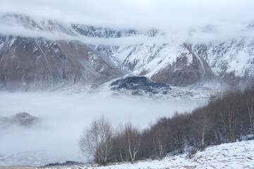 Georgian mountains. Kazbegi. Snow hills, epic clouds