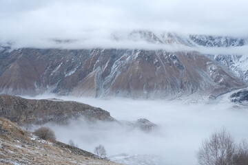 Georgian mountains. Kazbegi. Snow hills, epic clouds