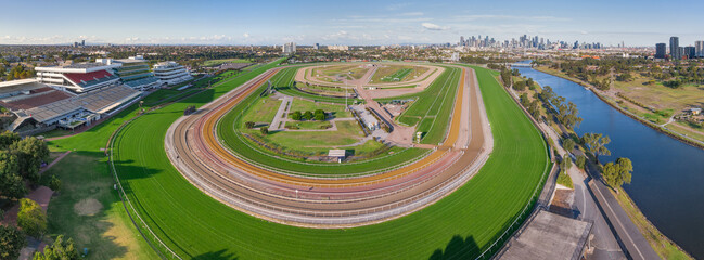 Panoramic aerial view of a wide bend on a horse racing track with a river running along side