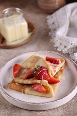 homemade thin pancakes with fresh strawberries