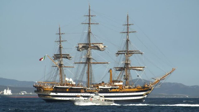 Telephoto shot of Italian Amerigo Vespucci Tallship, military vehicle passing by