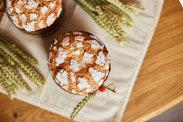 Easter cake with rustic decoration, wheat on wooden table the holiday