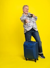 woman with a suitcase. Studio colored background. blue yellow. Happy, plump woman. bodypositive, big size, plus size