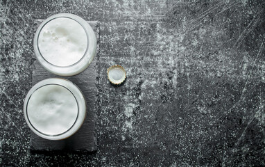 Two glasses of beer and cover.