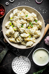 Dumplings with beef, tomato paste and sour cream.