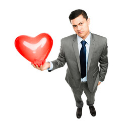 A young businessman holding a heart isolated on a PNG background.