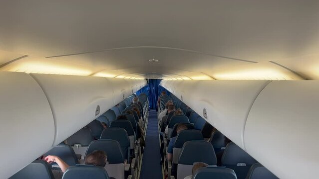 Back of Aircraft ceiling inside plane cabin. Passengers seen from above. Traveling flight concept